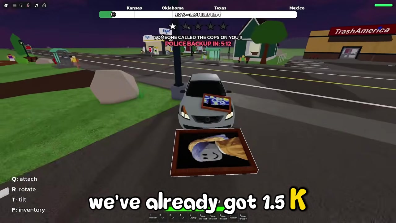 Holding a painting beside a car with Q: attach, R: rotate, T: tilt, and F: inventory prompts